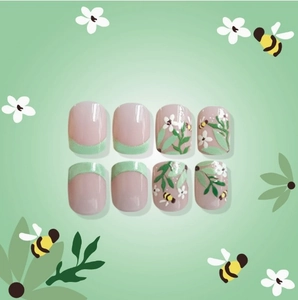 French tip floral press-on nails with bee art and mint green accents on pink base