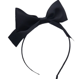 Elegant black oversized bow headband for women featuring fine textured fabric on white background