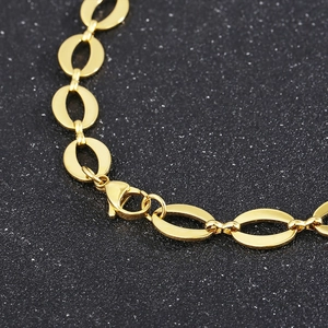 Close-up of golden stainless steel oval link chain necklace with lobster clasp detail