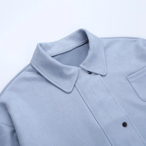 Detail shot of the lapel and metal buttons on a light blue faux suede jacket for men