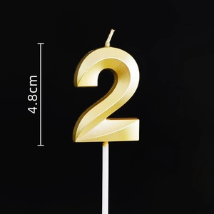 Detail of golden number 2 birthday candle with 4.8cm height and metallic faceted design