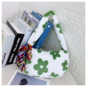 Close-up of fluffy white faux fur handbag with green floral patterns and silk scarf detail