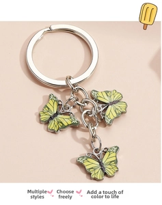 Detail of yellow enamel butterfly pendants on a silver metal keychain with chain