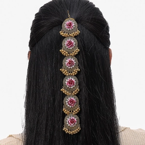 Bohemian gold head chain with pink roses and tassels displayed on long black hair