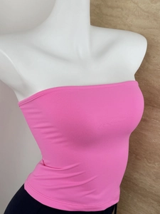 Detailed close-up of bright pink ribbed knit tube top on white mannequin stand