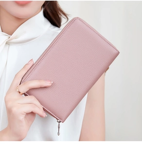 Close-up of a hand holding a pink lychee-patterned genuine leather wallet with zipper