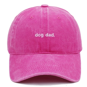 Close-up of dog dad. embroidery on pink washed cotton baseball cap with vintage texture