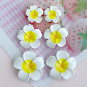 Glossy white and yellow resin plumeria flowers in three sizes for DIY hair accessories