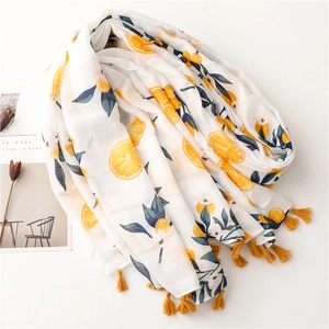 Lightweight cotton linen scarf with vibrant orange print and yellow tassels on white surface