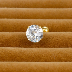 Close-up of a gold four-prong round zircon stud earring with a secure screw-back closure