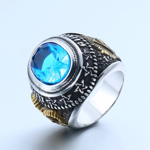 Detail of vintage Masonic ring showing gold relief carving and blue faceted gemstone