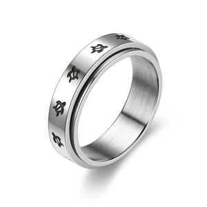 Macro view of spinner ring featuring black turtle patterns on polished silver steel