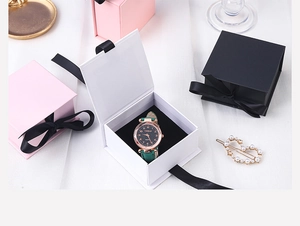 Detail of ribbon flip gift boxes in pink, white and black for watches and jewelry