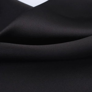 Detailed macro view of the smooth, glossy black satin fabric texture and premium sheen