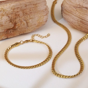 Detail of gold curb chain necklace and bracelet set with lobster clasp and extender