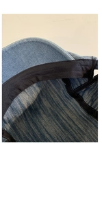 Detailed macro view of black sweatband and stitching inside blue denim beret hat