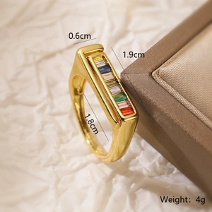 Detail shot of rainbow zircon gold ring with measurements 0.6cm width and 1.9cm length
