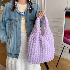 Close-up of light purple popcorn texture shoulder bag with 3D bubble fabric detail
