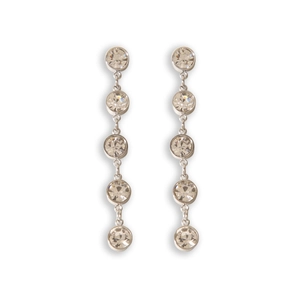 Macro detail of silver drop earrings with five sparkling round-cut crystals on white background