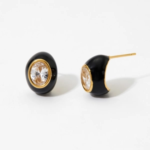 Close-up of vintage teardrop earrings with black oil drip and zircon in gold plating