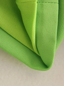 Macro shot showing high-quality green knit fabric texture and premium weaving detail