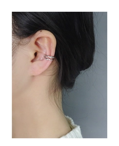 Close-up of a double-layered wavy silver ear cuff on model ear with minimalist design