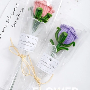 Handmade crochet rose bouquet with pink and purple yarn flowers in elegant gift packaging