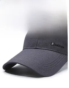 Detail view of the firm long brim and textured fabric of the dark grey baseball cap