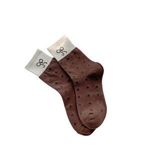 Brown mid-calf socks with black polka dots and cream cuff featuring a bow embroidery