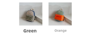 Detail view of mini color-block canvas backpacks in green and orange with front zipper