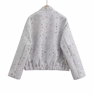 Detail of silver sequin jacket back showing premium fabric texture and elastic hemline