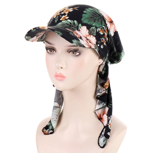 Detailed view of long tail floral headscarf cap with leaf pattern on female model