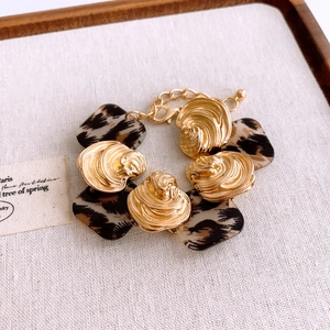 Detailed shot of resin square leopard print link bracelet on a beige linen background