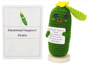 Detail of handmade crochet emotional support pickle with motivational text card and base