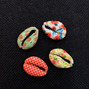 Four natural painted seashell beads with unique patterns for DIY jewelry crafting