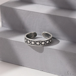 Macro detail of S925 sterling silver ring with embossed star pattern on stone