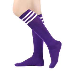 Detail of purple knee-high socks with three white stripes and soft cotton knit texture