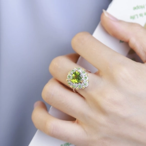 Elegant silver ring with teardrop green peridot and halo floral micro-pave setting