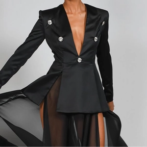 Detail eines schwarzen Satin-Blazerkleids mit Strassknöpfen und transparentem Tüllrock