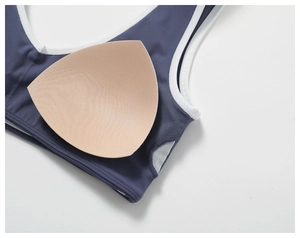 Detail of navy yoga bra with removable pads and breathable mesh lining inserts
