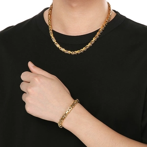Golden Byzantine link necklace and bracelet set in stainless steel on a model