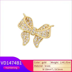 Elegant gold brass bow pendant with sparkling cubic zirconia, 18mm x 19.5mm size