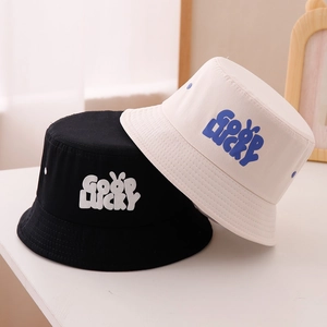 Close-up of GOOD LUCKY cotton canvas sun hats in black and beige for kids