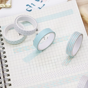 5-roll watercolor washi tape set with geometric patterns on a spiral notebook