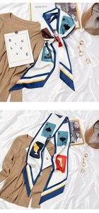 Detail of vintage French silk scarf with poker card print tied in a bow on a white fabric
