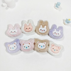 Detail of plush cartoon animal bear and rabbit charms in purple, pink, brown and white colors