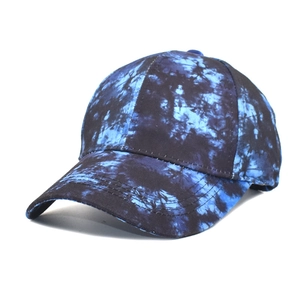 Close-up of reinforced stitching and dark blue tie-dye pattern on baseball cap brim