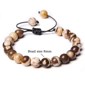 Detail of 8mm natural picture jasper beads on a black adjustable hand-woven cord bracelet