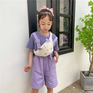 Kids unicorn chest bag with white iridescent sequins worn by a girl in outdoor setting