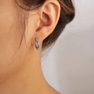 Silver twisted Mobius hoop earrings for women with minimalist stainless steel geometry